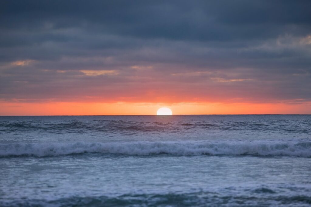 Sunset over an ocean and waves